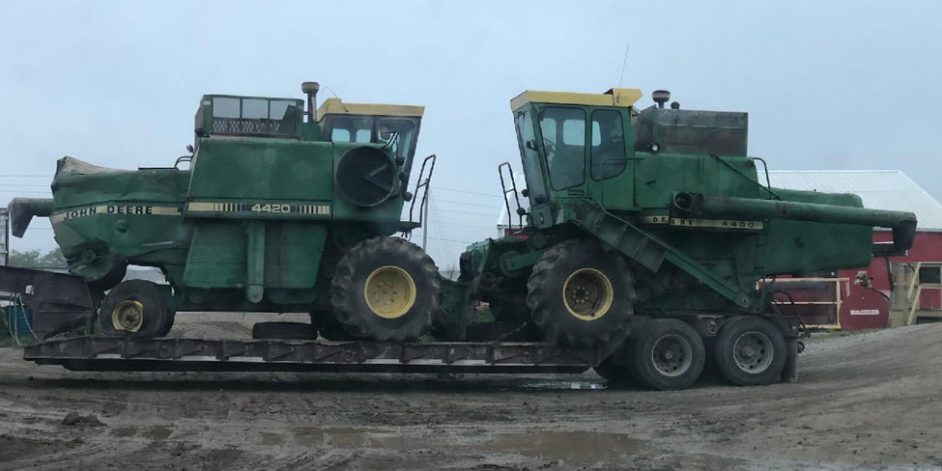 Two combines loaded onto a Grandinetti's flat bed